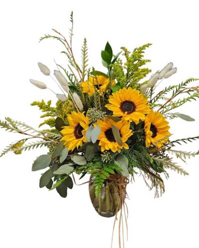 <p>Sunflowers in a vase with seasonal greens and dried bunny tails.</p>
